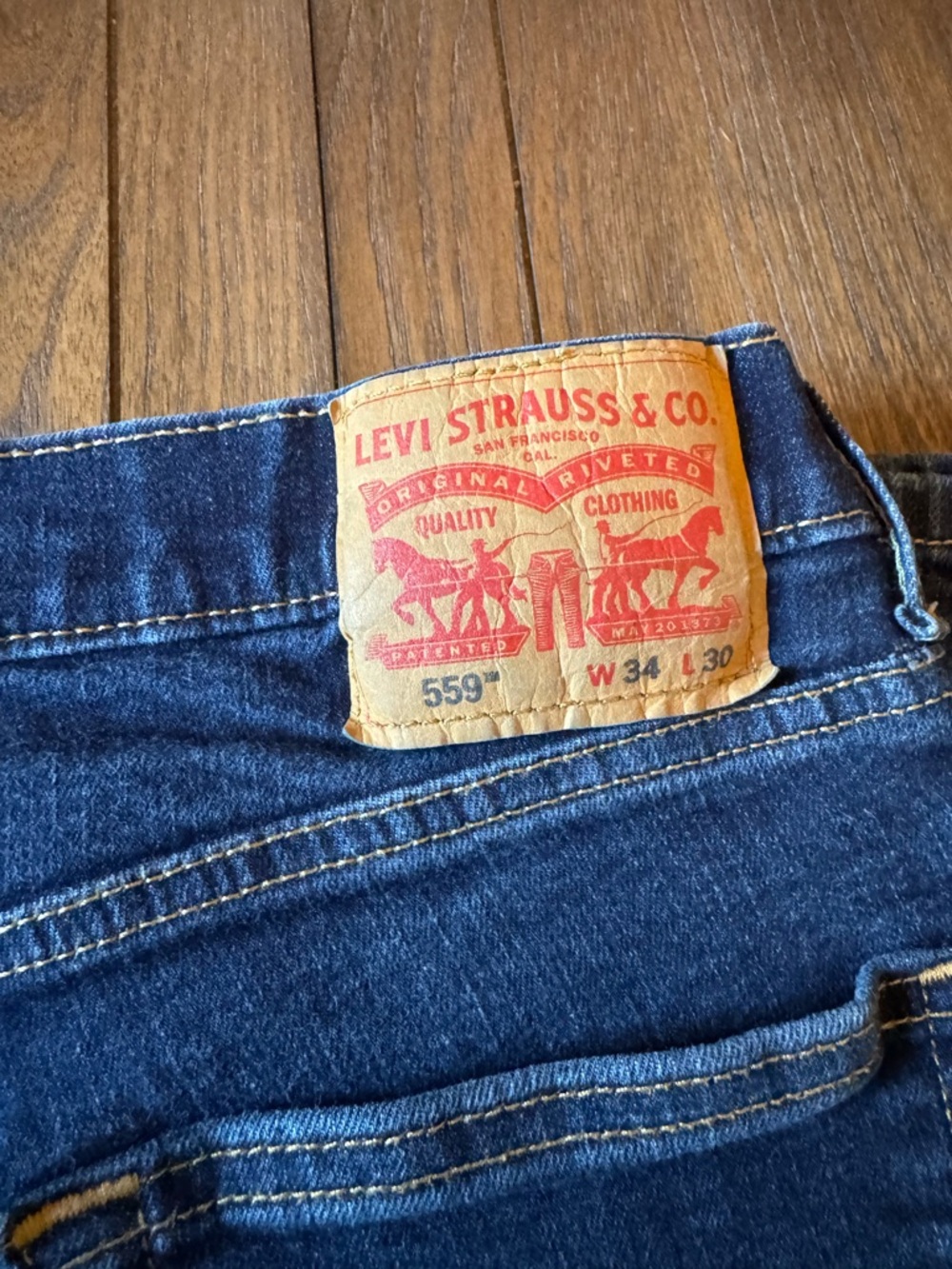 Levi's Men's 559 Relaxed Jeans in Indigo Blue with Tan Patch